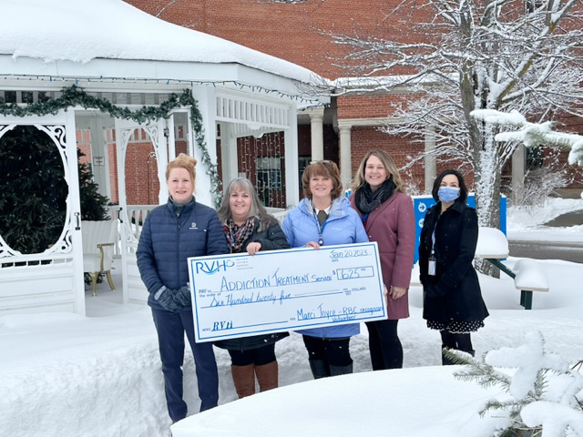 five women accepting cheque